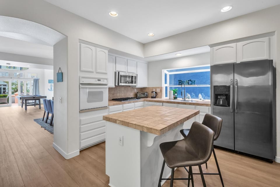 Fully-equipped kitchen with barstool seating.