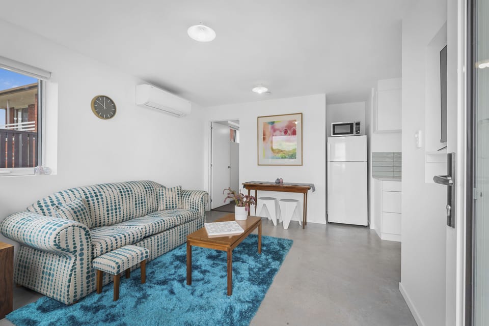 Standard Apartment | Living area | 50-inch flat-screen TV with digital channels
