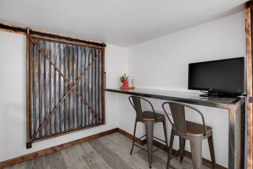 Stay connected with the desk featuring a monitor and HDMI cable and a large closet