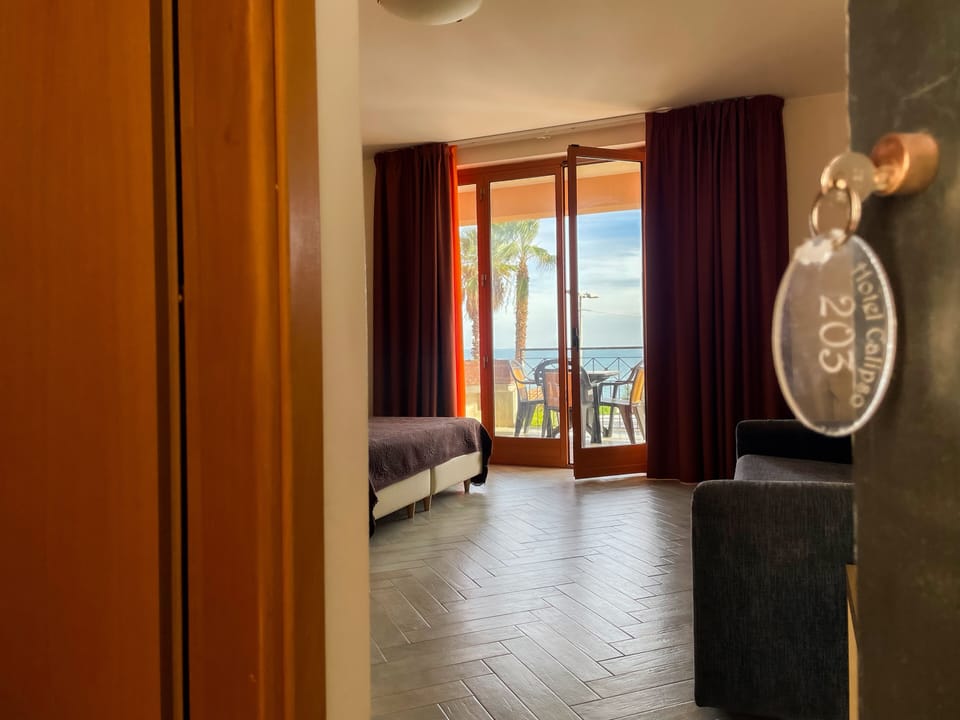 Deluxe Quadruple Room | Minibar, in-room safe, desk, blackout drapes