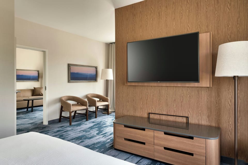 Hypo-allergenic bedding, desk, laptop workspace, blackout drapes
