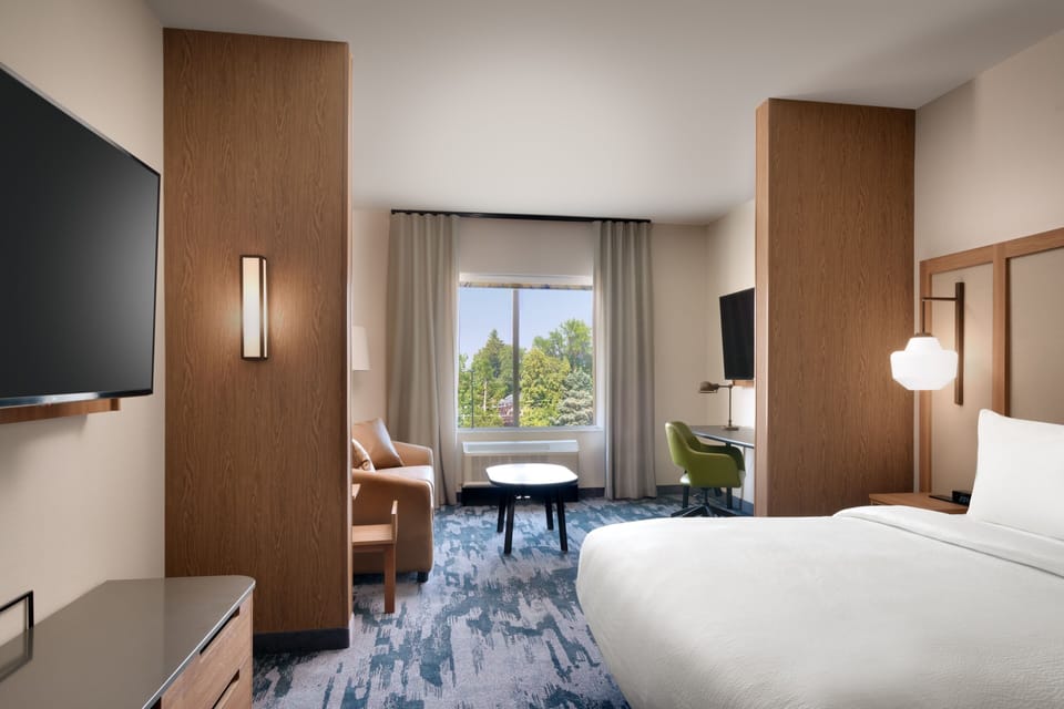 Hypo-allergenic bedding, desk, laptop workspace, blackout drapes