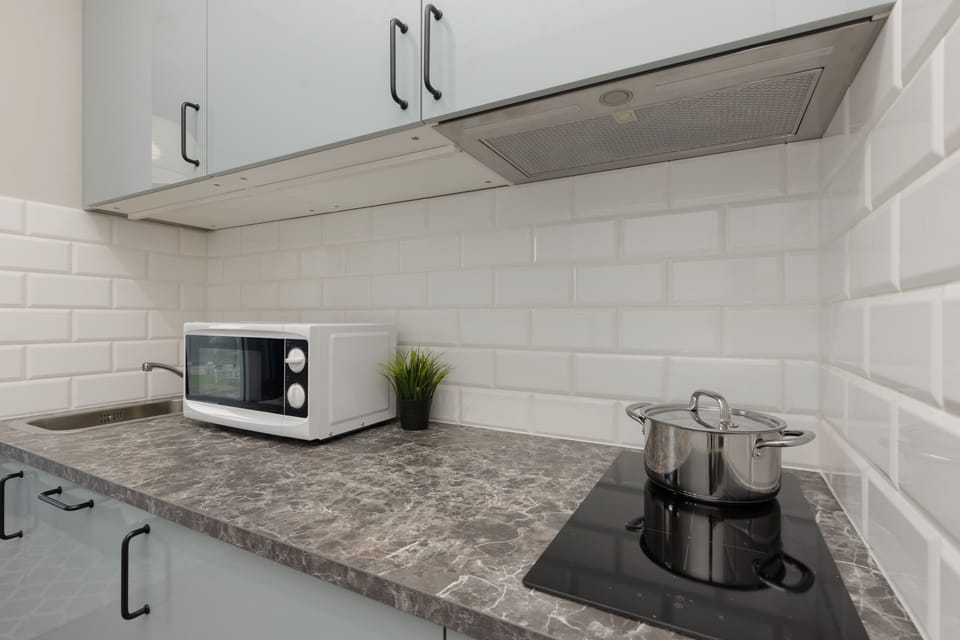 A closer look at the kitchenette with a built-in stove, sink, and countertop space for meal preparation.