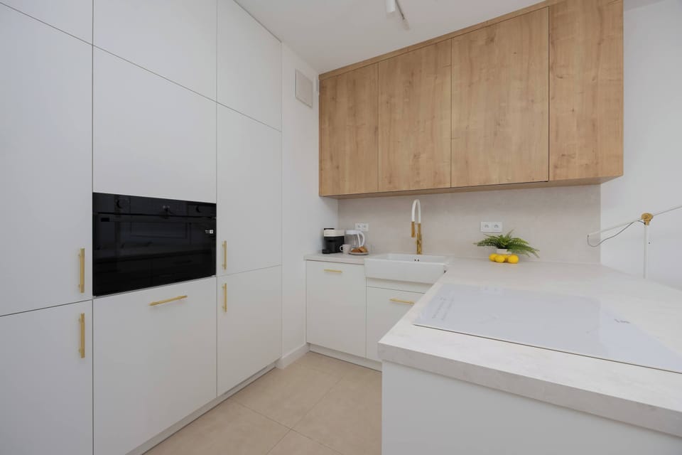 Bright kitchen with cooking utensils. 