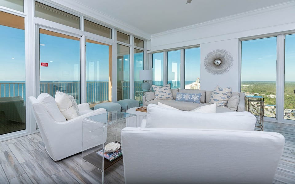 Relax in the airy living space, gazing out at the coast through panoramic windows while feeling the gentle breeze