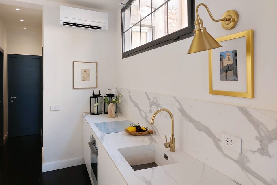 Large window in kitchen area fills apartment with light.