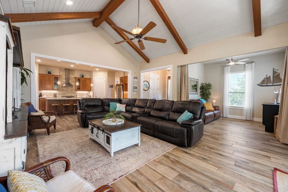 Main living area with large sectional and flat screen tv.