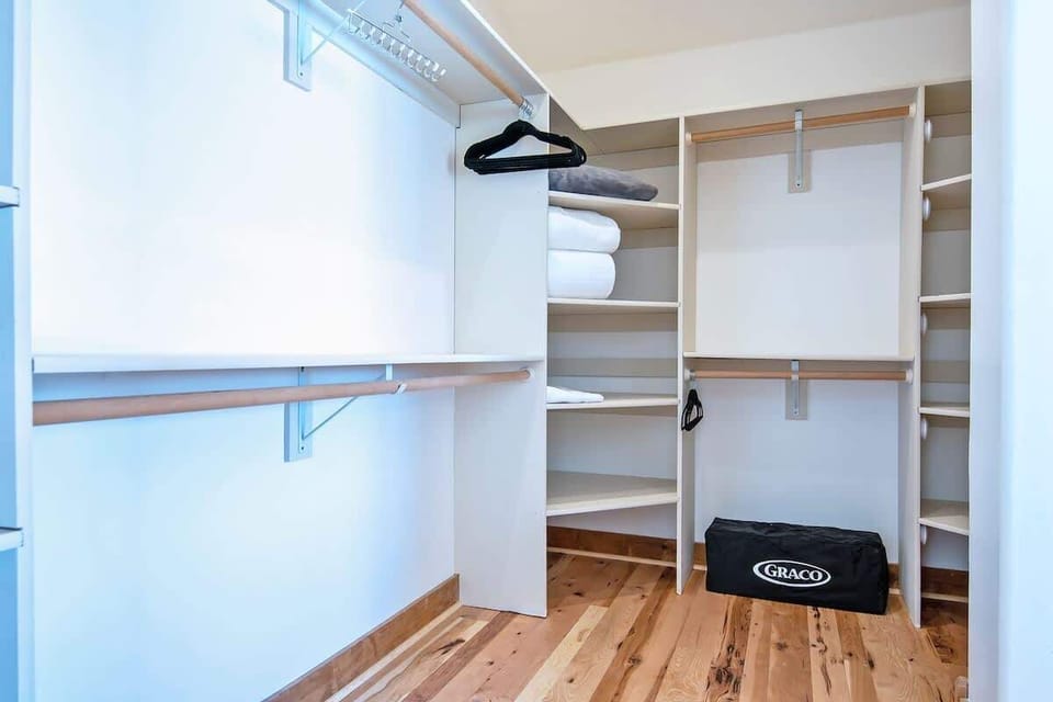 This walk-in closet is spacious and accessible from the primary bedroom. We also have a Pack 'n Play for the young ones!