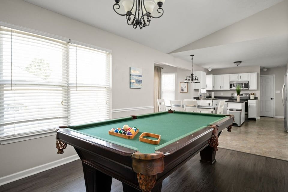 Pool table with a view of the kitchen