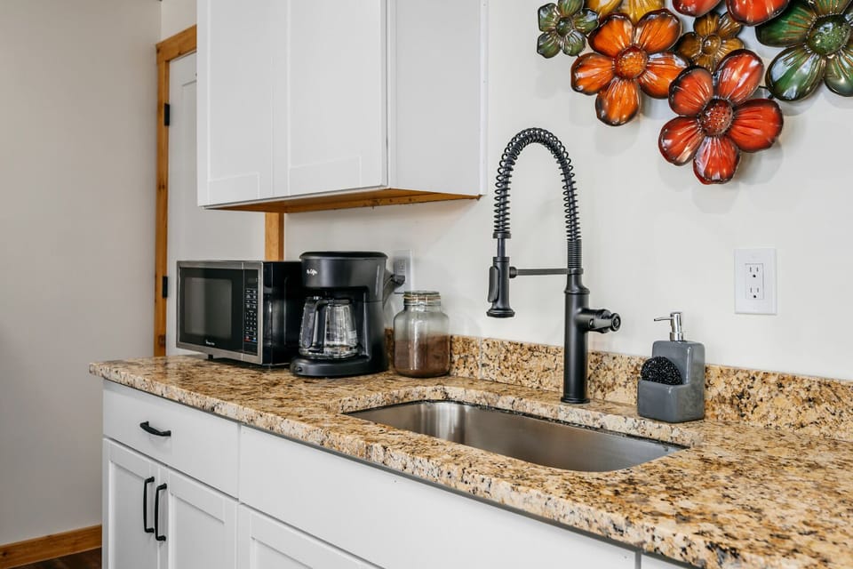 Sleek granite countertops and vibrant decor make meal prep a delight!
