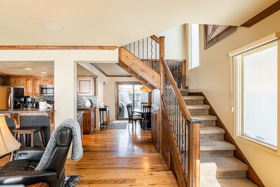 Living Room with plush couch, 2 electric, leather recliners, gas fireplace, and smart TV