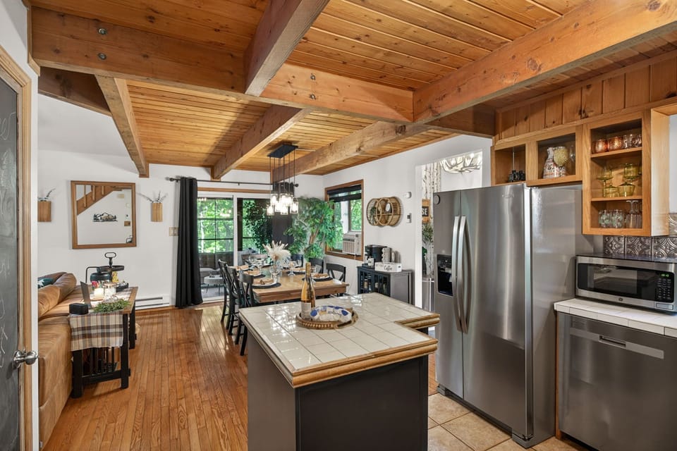 Kitchen into dining room view. Three season sunroom behind that