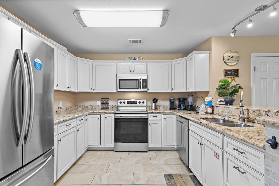 Bright white cabinetry, granite countertops, and all the appliances you need to make every meal feel like home.