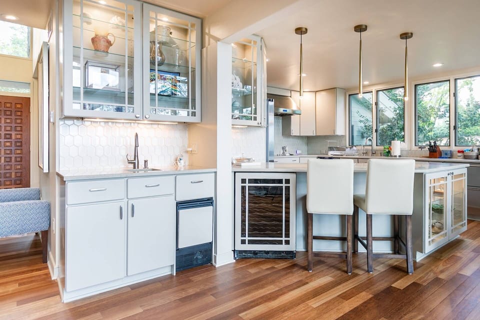 The bar is stocked with barware, a wine fridge and an ice-maker.