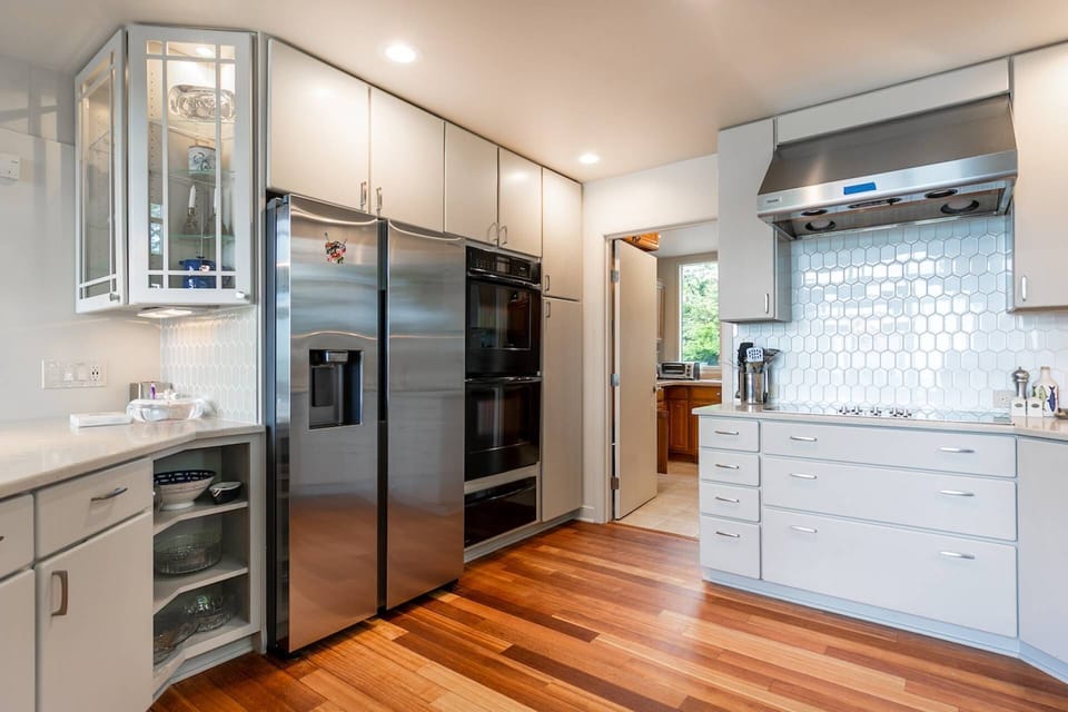 The kitchen has a large refrigerator, double oven, warming drawer and 2 cooktops.