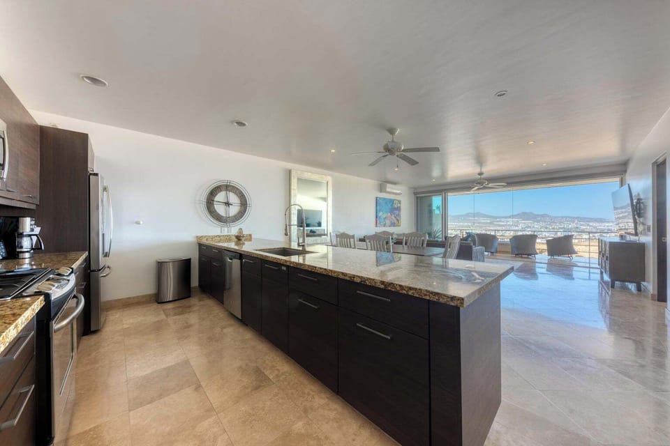 Open layout view of kitchen, dining, living, and outdoor patio to Sea of Cortez