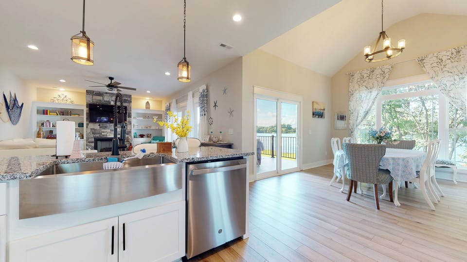 Kitchen looking into the Dining and Main Porch overlooking the lake. 