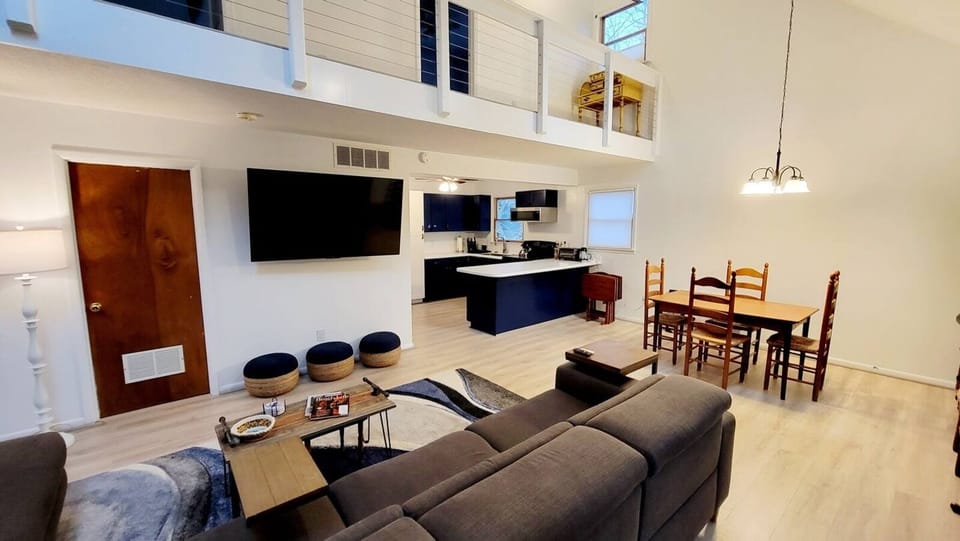 Family Room with massive 8+ person sectional, 2 reclining chairs on end.  Large seating area kitchen. Table opens up to seat 6 and 8.   3 bar stools for even more seating.
65" Smart TV