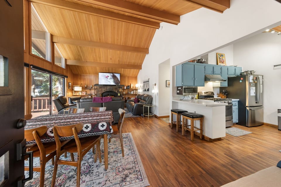 Step into your mountain retreat where vaulted wood ceilings and warm hardwood floors create the perfect alpine atmosphere for relaxation and gatherings.