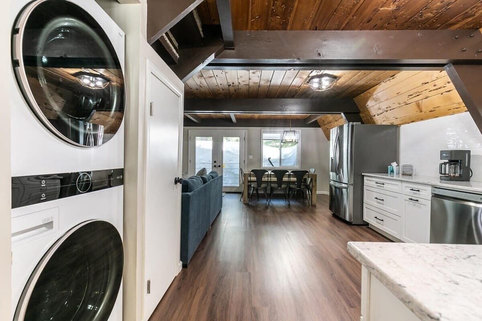 The view down the front hallway into the spacious living room/kitchen/dining area.