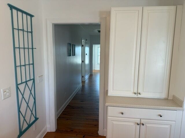 Step into your bright hallway where thoughtful built-ins provide ample storage and a charming teal trellis adds coastal charm to your space.