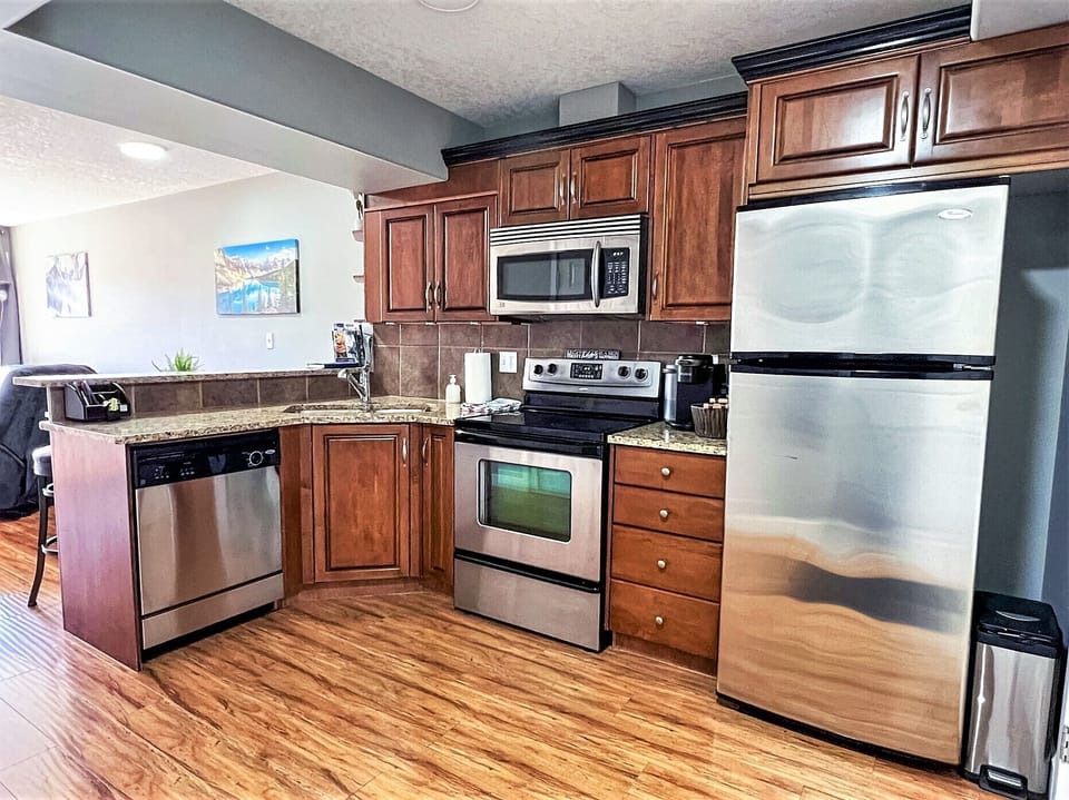 Nice, Fully Stocked Kitchen With Breakfast Bar!