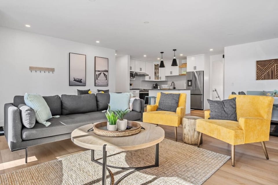 Living room with a Smart TV, electric fireplace, and cozy seating options.
