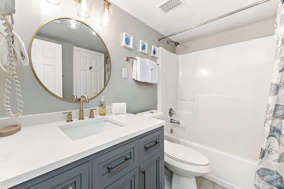 Rejuvenate in your en suite bathroom with a quartz sink countertop and gold finishes.