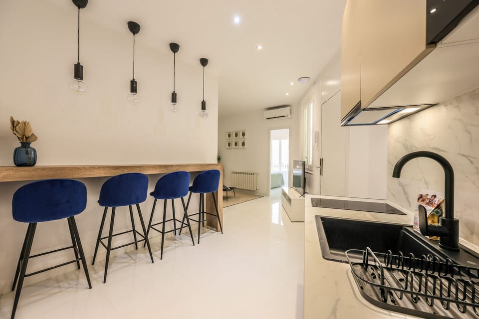 Kitchen area with high table and stools