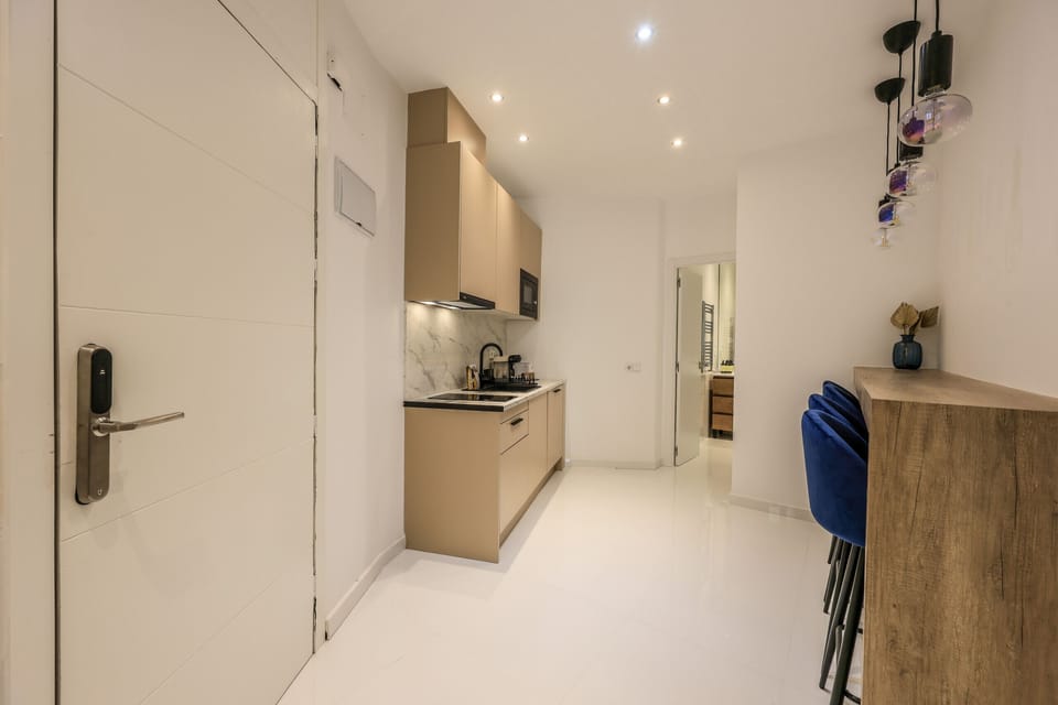 Kitchen area with high table and stools