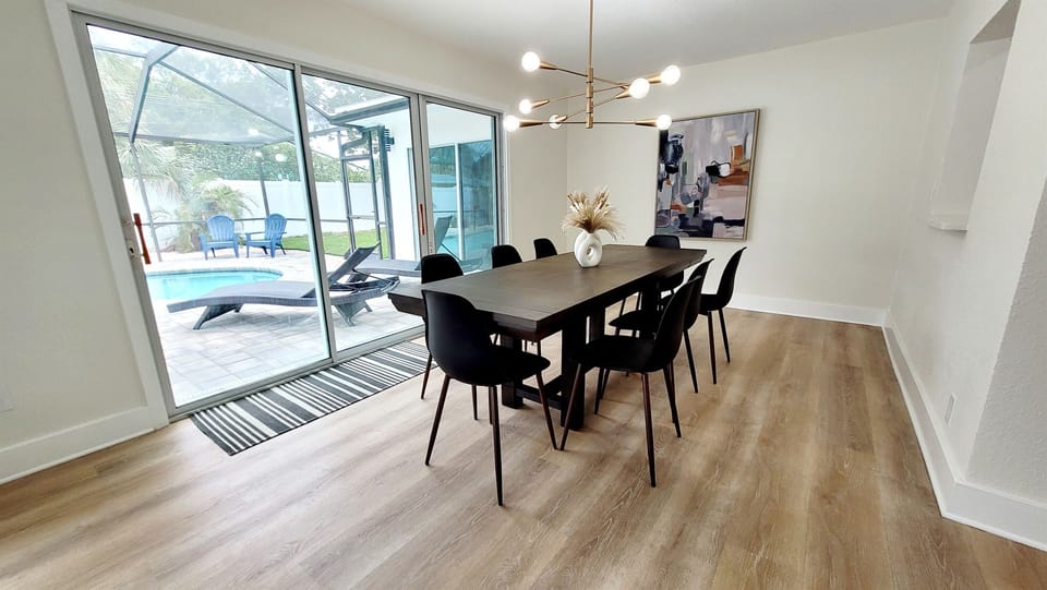 The large dining room looks out onto the pool and has lots of seating for dinner or game night!