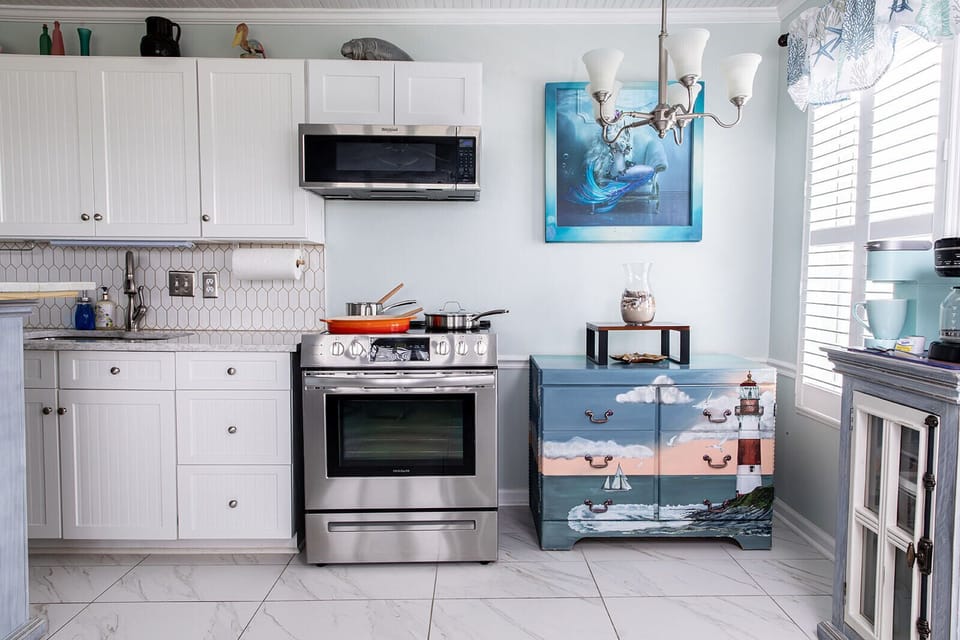 The full kitchen is finished with quartz countertops and includes a stove and oven, microwave, full refrigerator and freezer, and storage for dry goods. Whether you’re cooking dinner or keeping things simple, everything you need is within reach.