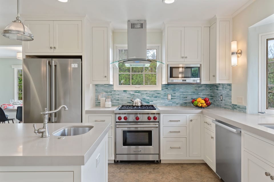 Large kitchen with stainless steel appliances in main house