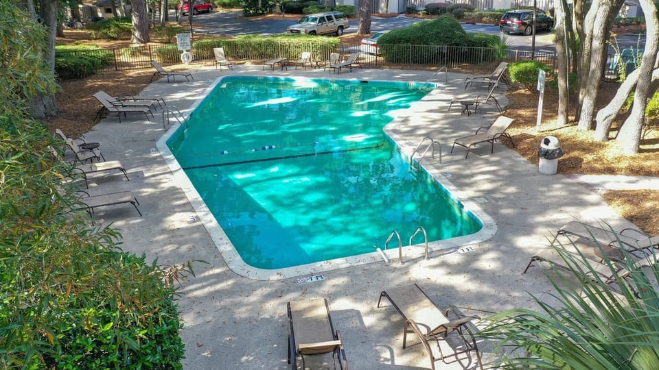 The pool area provides plenty of space for lounging, while the large swimming pool and adjacent wading area create a perfect setting for families.