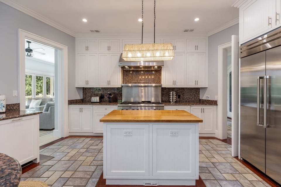 The commercial-style gas range, oversized refrigerator, and abundant workspace make it easy to prepare meals.