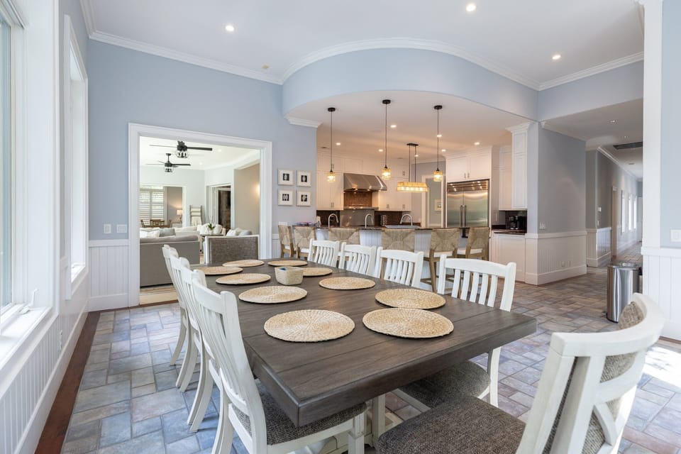 An open-concept dining room with a view of the kitchen and living area, perfect for entertaining.