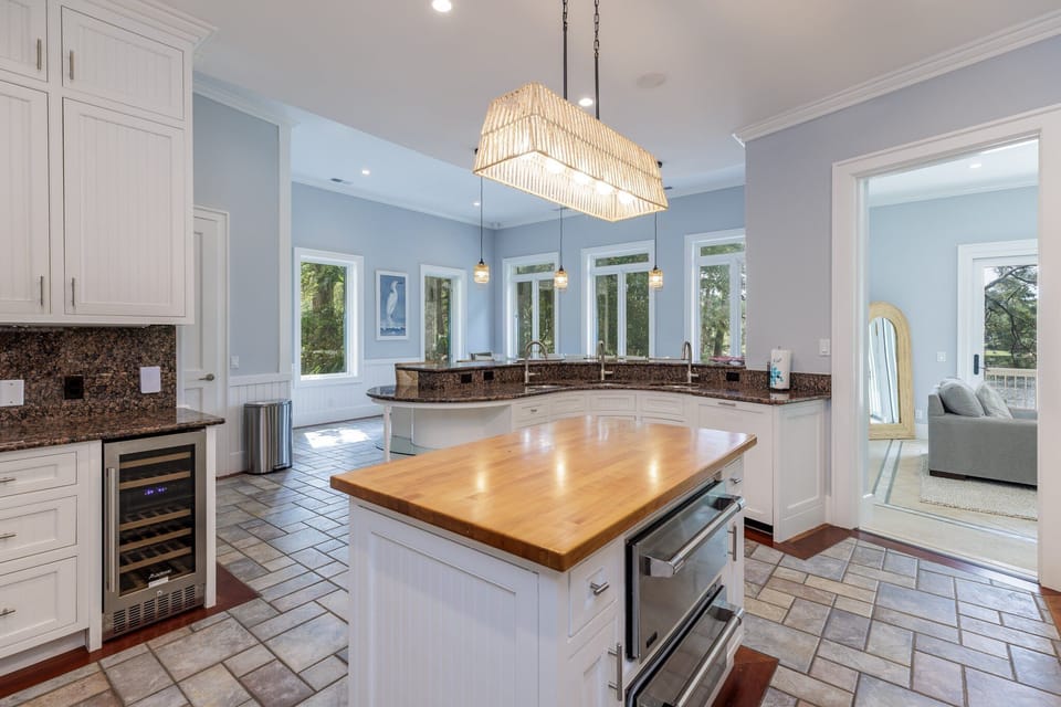 Granite countertops, generous prep space, and thoughtful lighting create an ideal setting for cooking, entertaining, and gathering with ease.