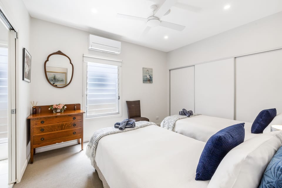 2nd bedroom with 2 King Single beds, air-con & ceiling fan, large wardrobes.