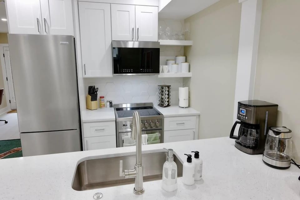 Kitchen with all the essentials such as coffee, tea, and cooking utensils!