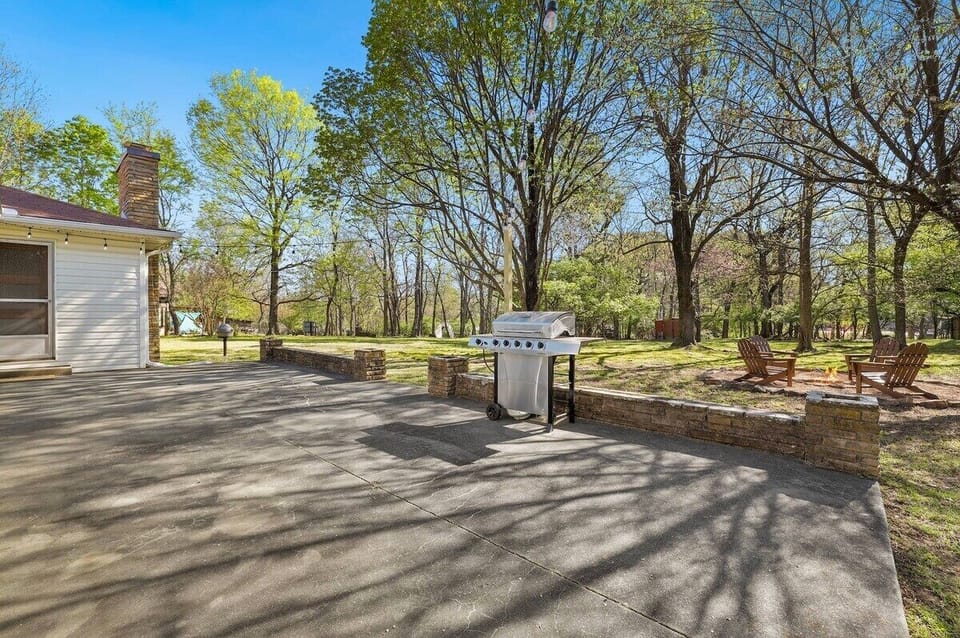 Outside, unwind in our outdoor living space! Head through the door in the second bedroom and you'll step out onto our back porch which leads to our large patio, where you'll find our BBQ grill.