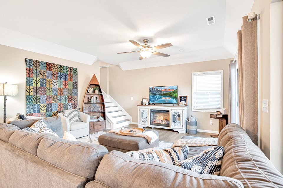 Beautiful quilt work compliments the rustic lake feel of the living area