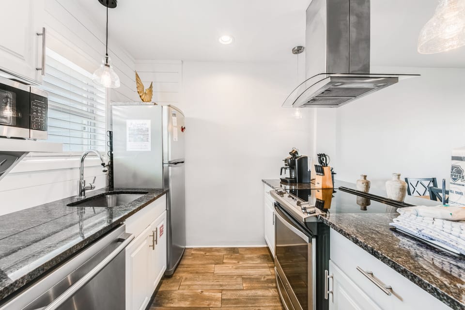 Step into your sleek galley kitchen with granite counters, stainless appliances, and everything needed for memorable meals.
