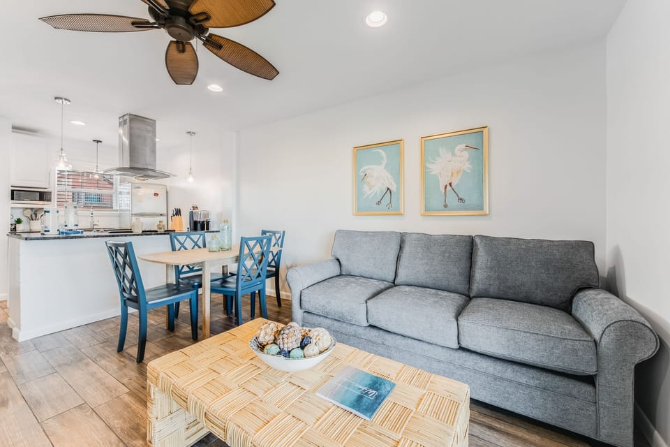 Relax in your bright, coastal-inspired living space with comfortable seating and an open kitchen perfect for preparing meals together.