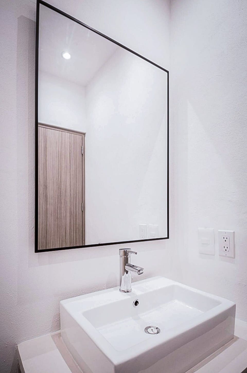 Bathroom sink with a mirror above it in this apartment