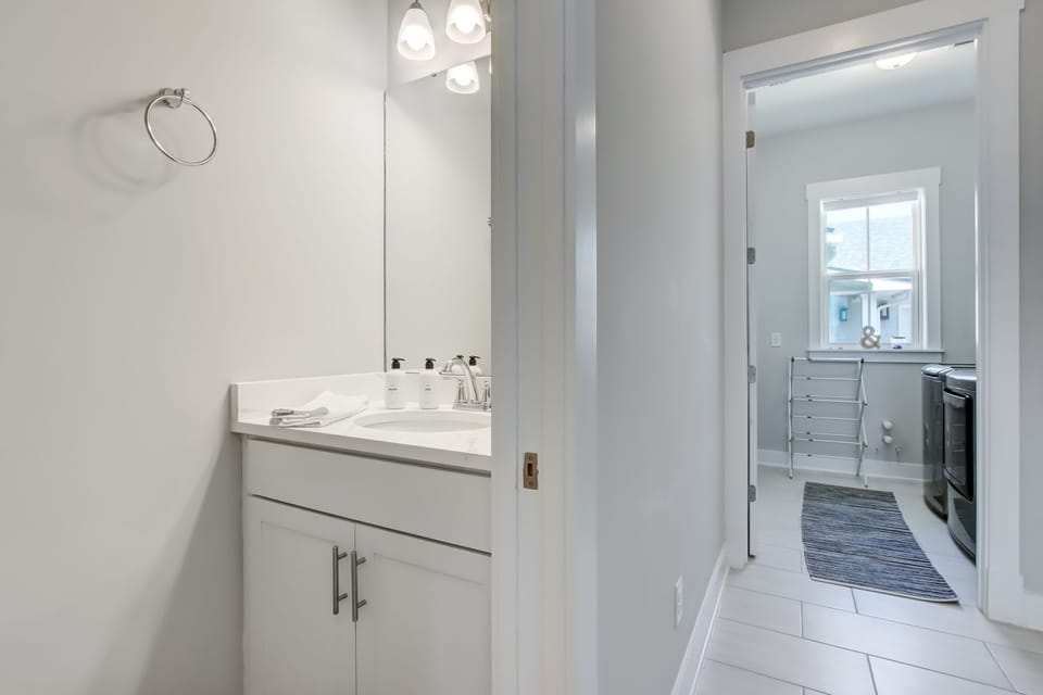 Half bathroom and laundry room located in hallway by back door 