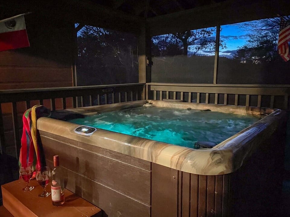 Hot tub after dark — glowing water and a quiet Smoky Mountain night
