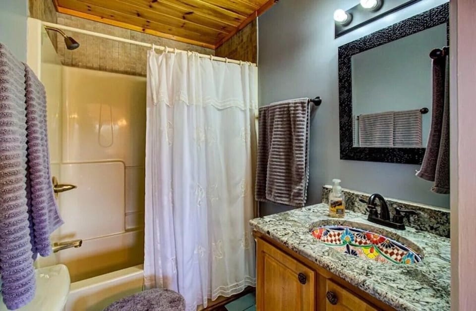 Bedroom 2`s ensuite — tub-shower combo and a hand-painted Talavera sink