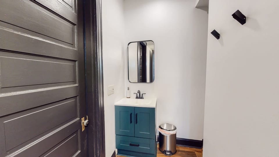 Full Bathroom 1: Additionally, you'll find a vanity mirror and sink placed in the bathroom hallway.