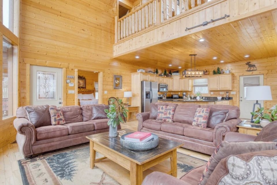 Relax in your spacious cabin retreat with vaulted ceilings, leather seating, and a fully equipped kitchen perfect for gathering.