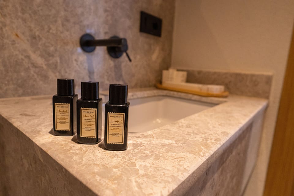 Deluxe Corner Room With Pool | Bathroom | Shower, rainfall showerhead, designer toiletries, hair dryer